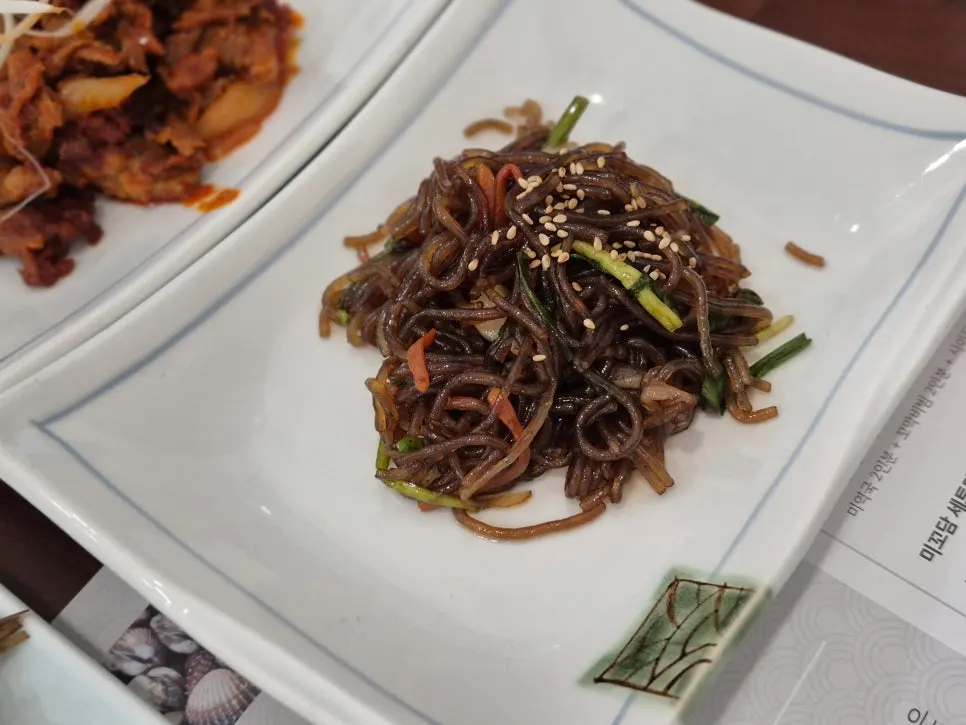 Japchae and grilled mackerel side dishes