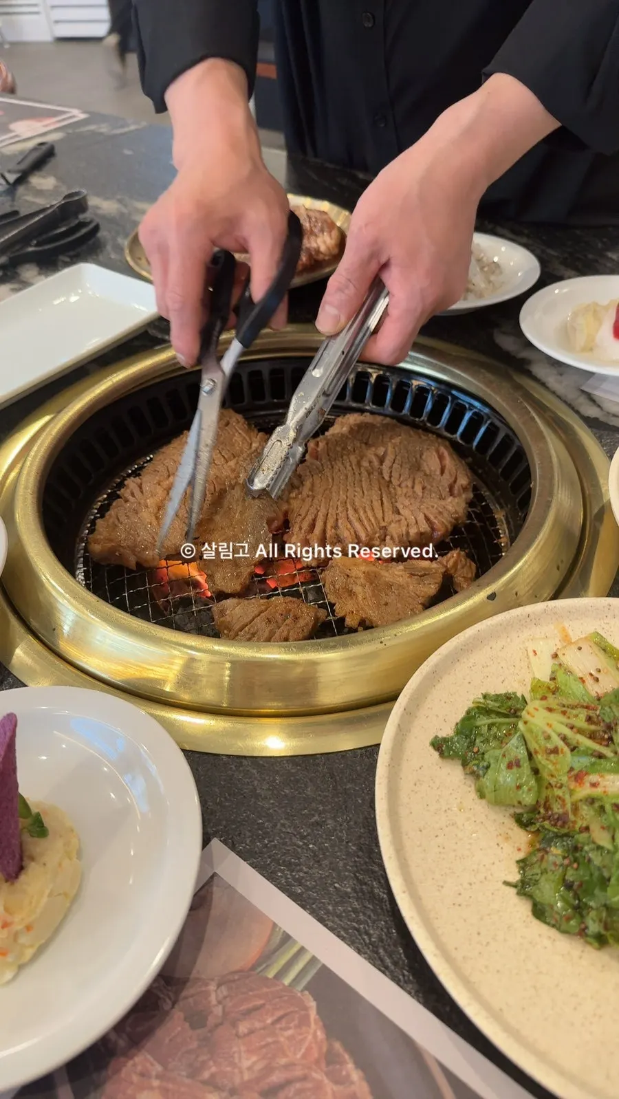 Staff tossing marinated pork while grilling it