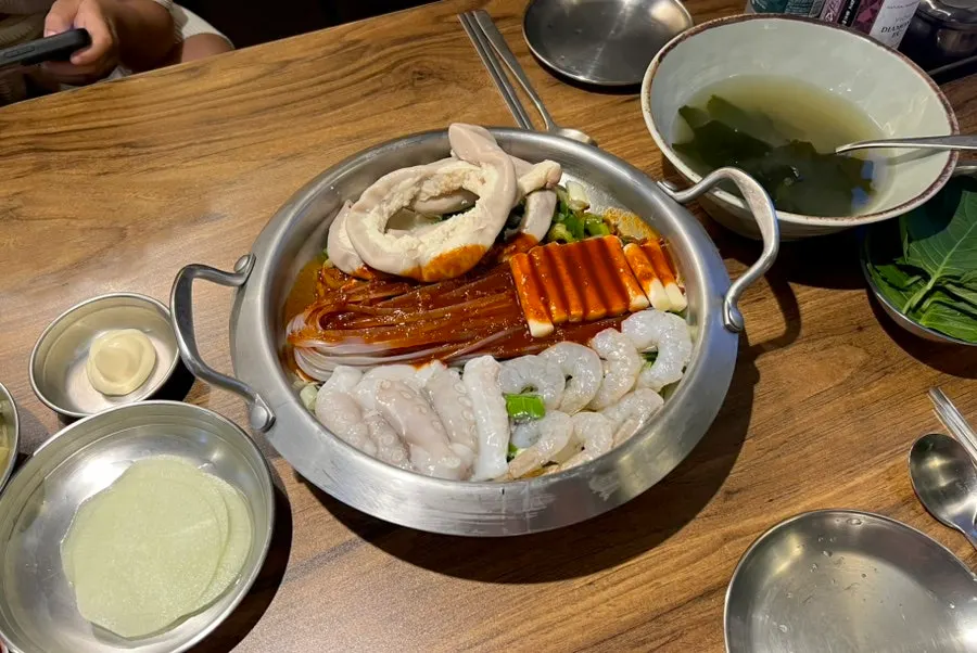 Nakgopsae deepened in color as the sauce soaks in