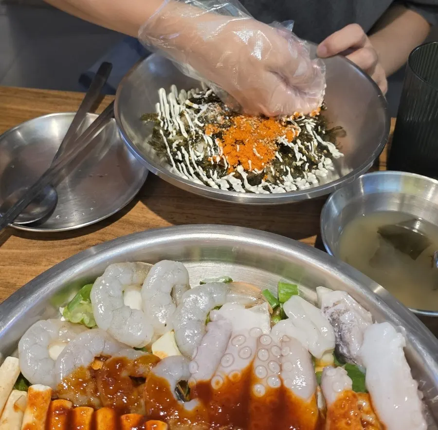 Table spread of rice balls and nakwoosae