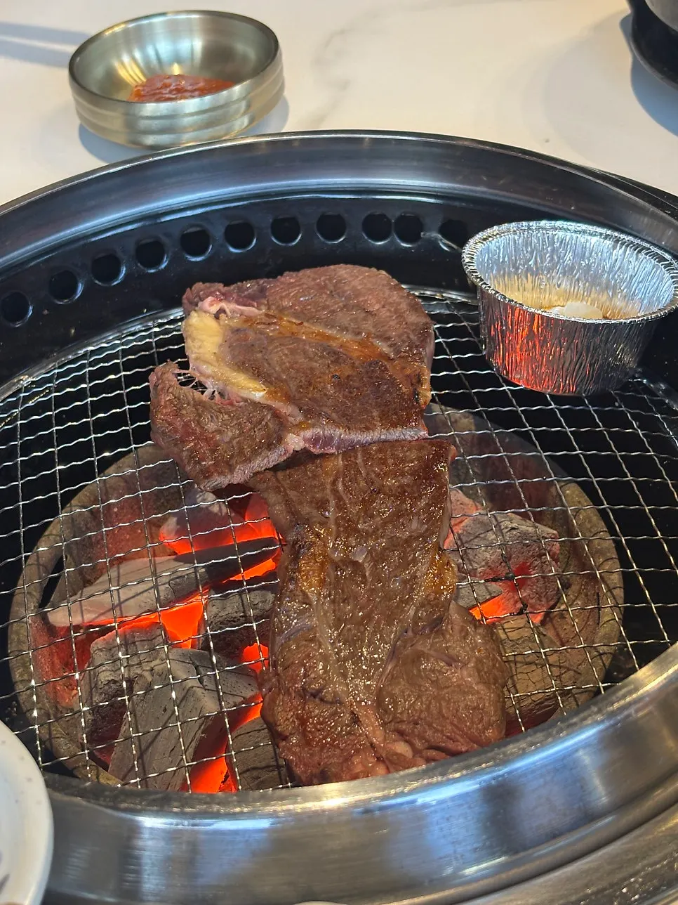 Hanwoo sirloin cooking on the grill