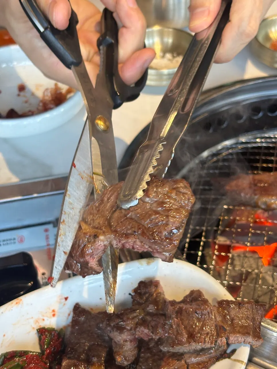 Bibim naengmyeon eaten alongside grilled meat