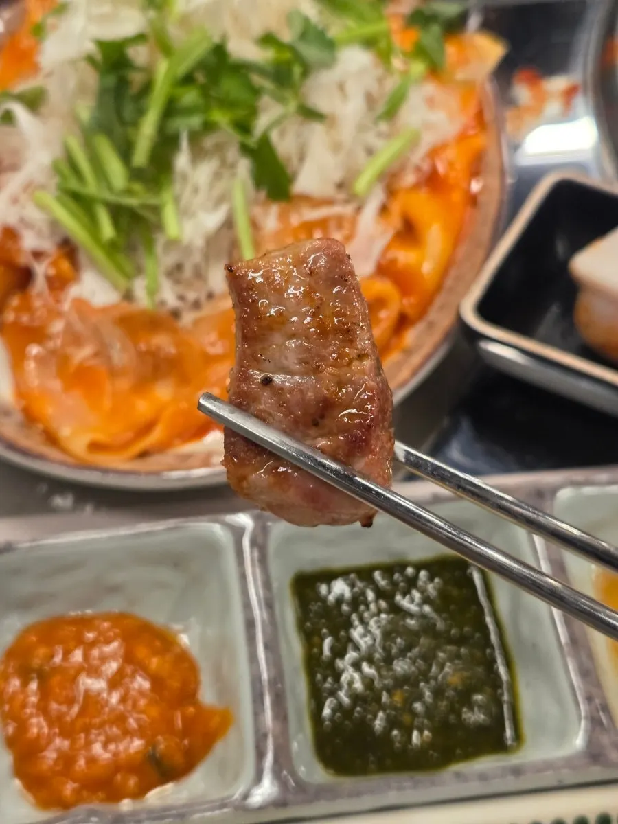 Menu board listing charcoal rock-salt pork belly and gochujang charcoal bulgogi
