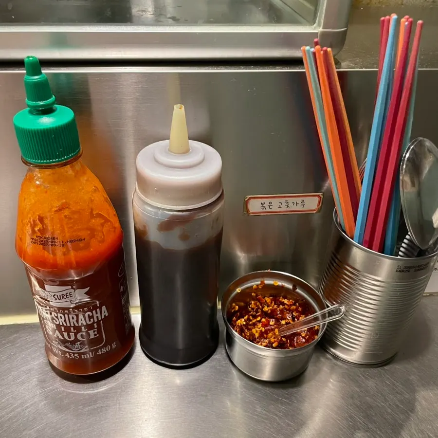 Chili sauce and hoisin sauce on the table
