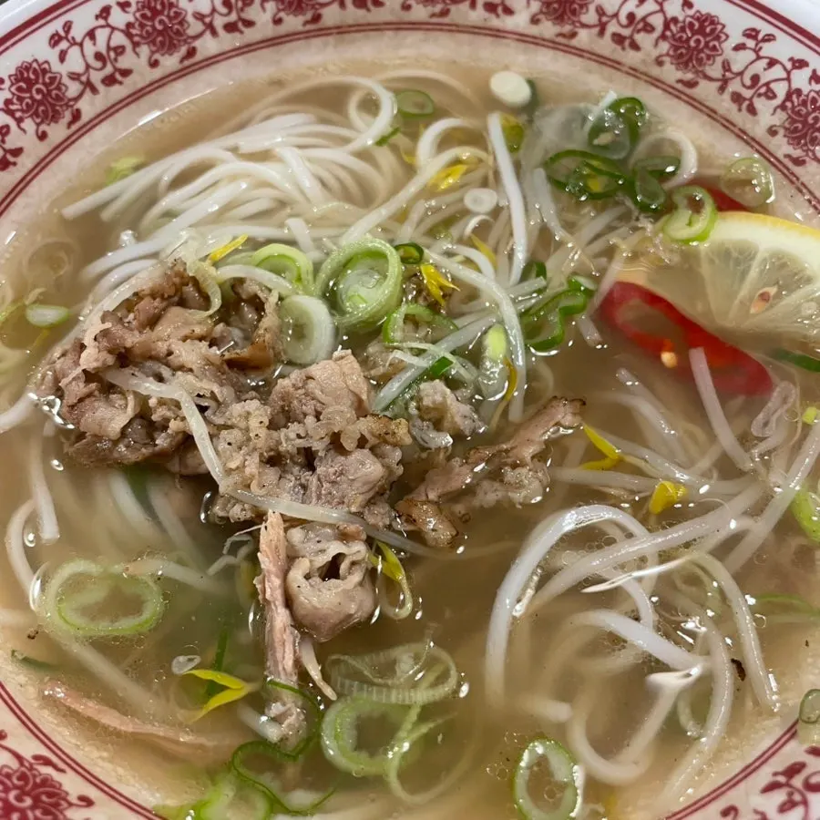 A spoonful of mixed pho broth