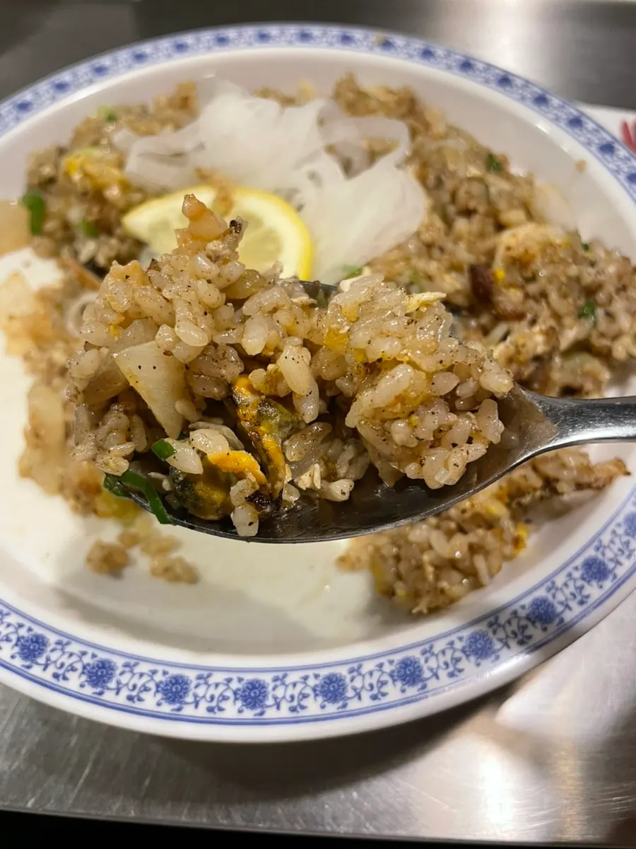 Side broth served with the seafood fried rice
