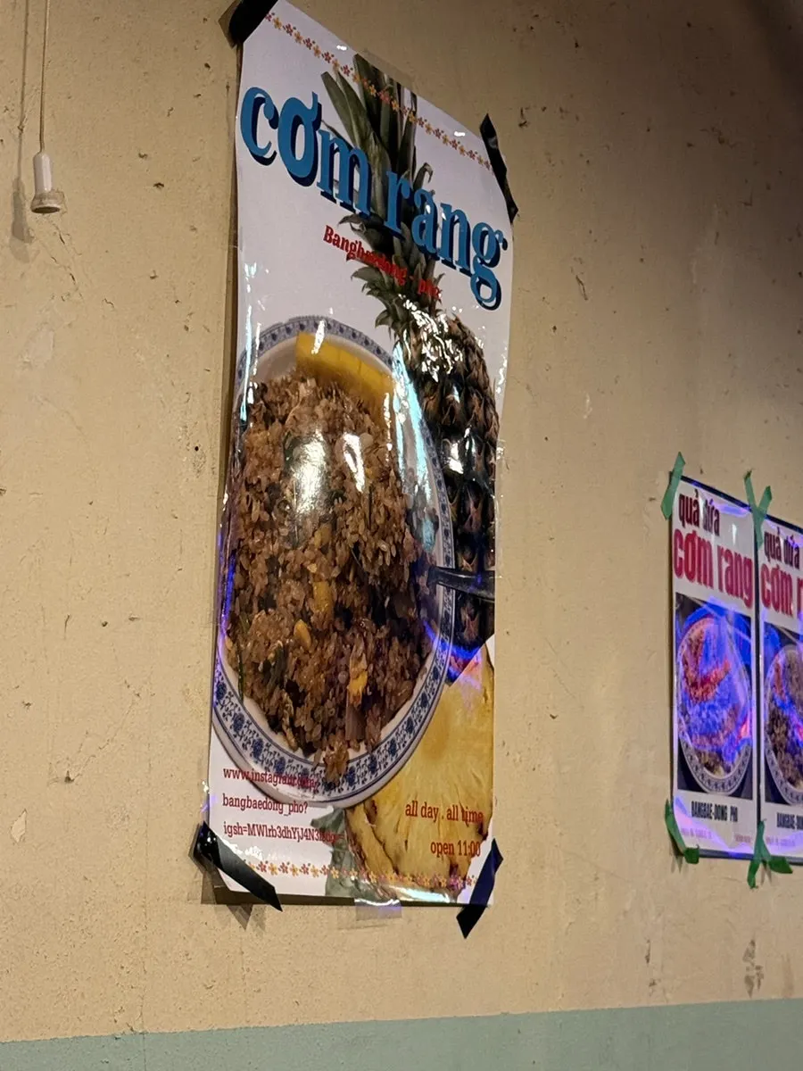 Vietnamese food posters and props on the wall