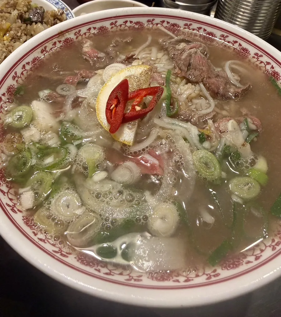 A large bowl of fresh tenderloin pho