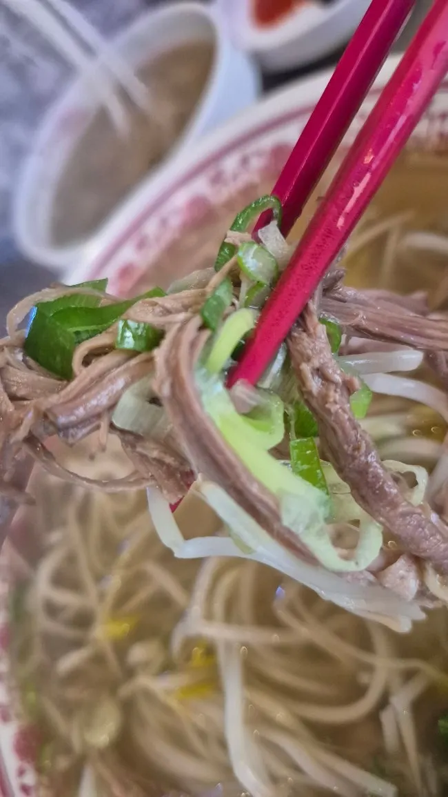 Close-up of pho topped generously with brisket