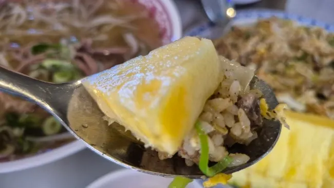 Table with pho and fried rice placed together