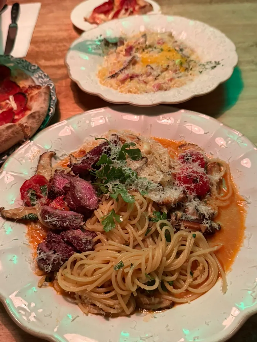 Signature pasta topped with steak