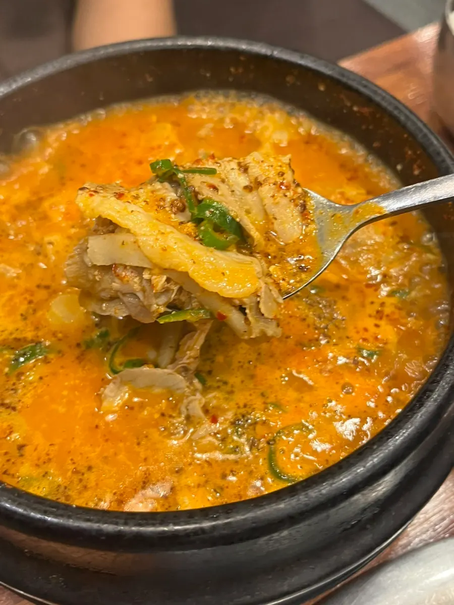 Spicy pork gukbap loaded with boiled pork