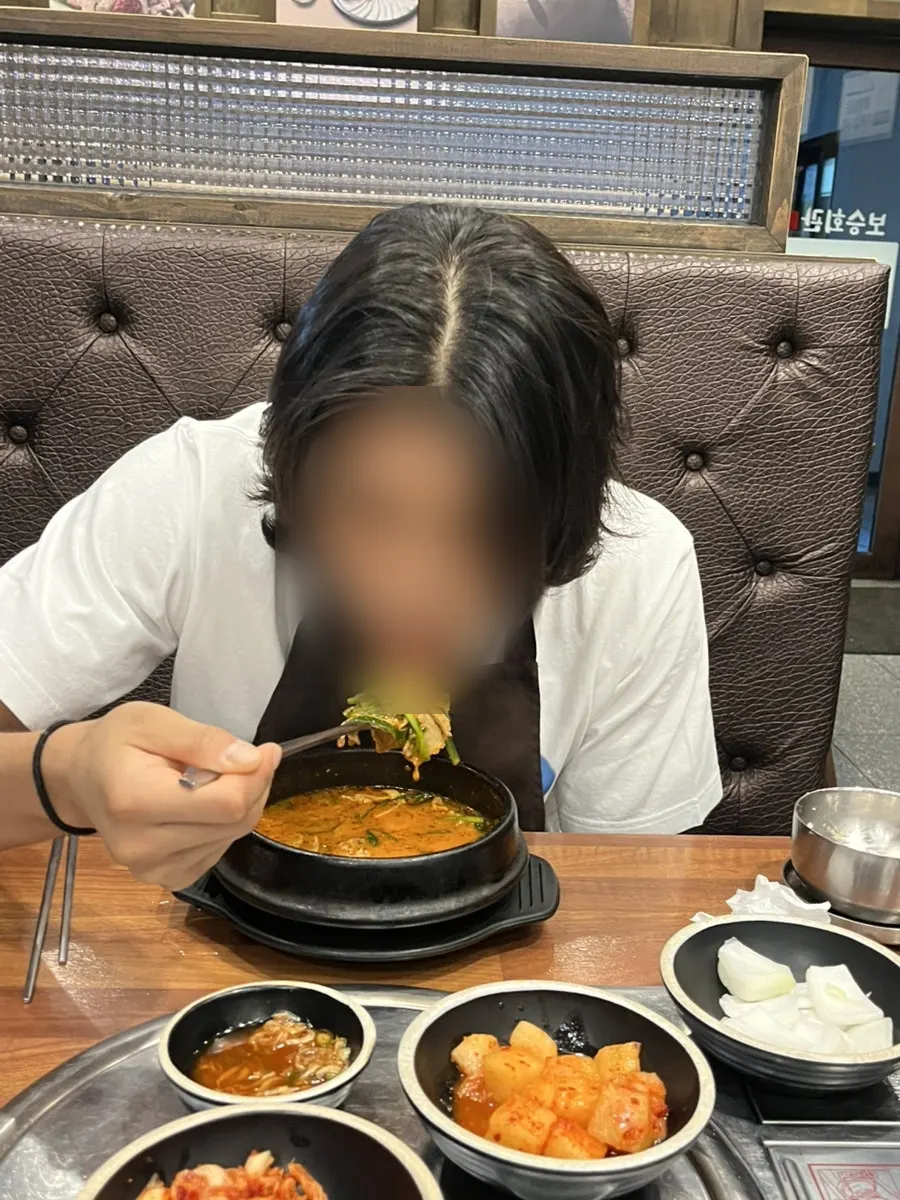 Spicy pork gukbap topped with chives