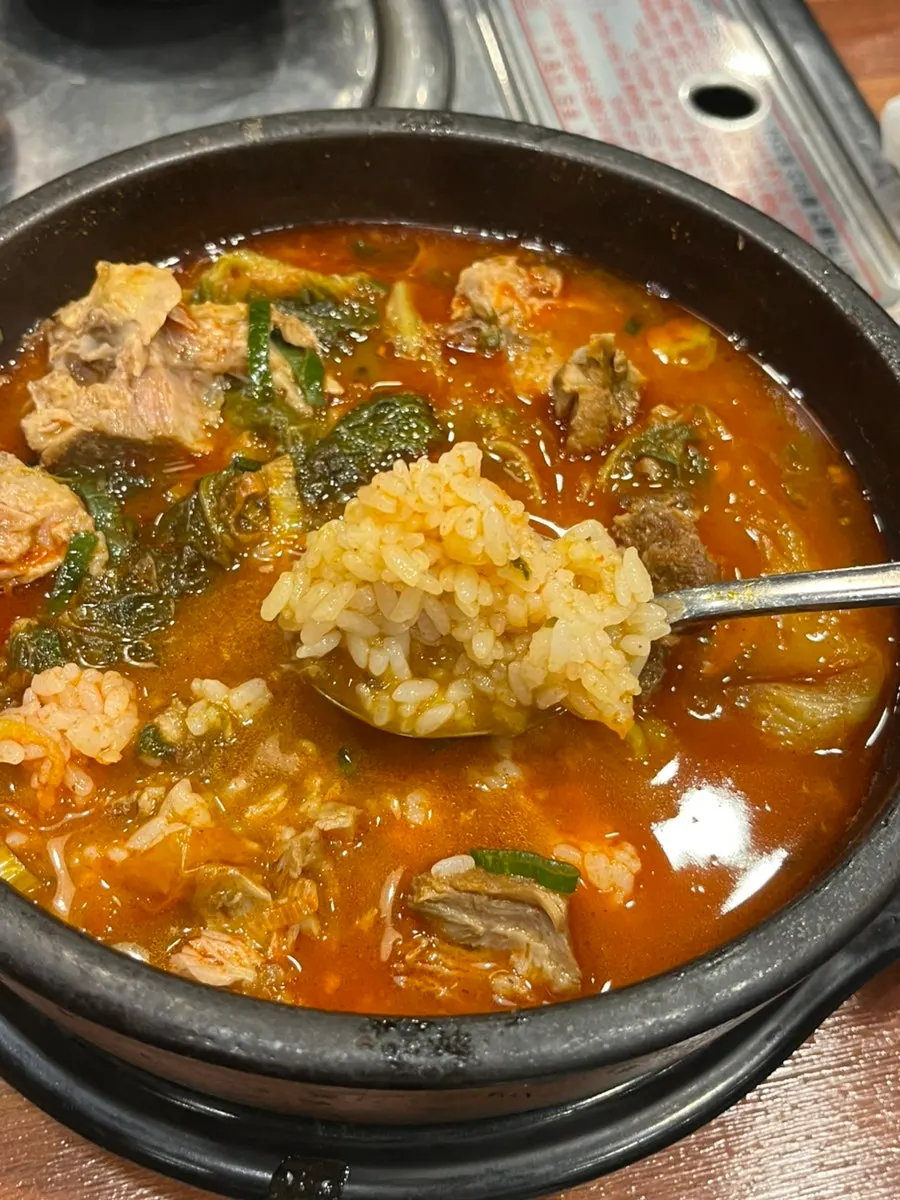 A spoonful of rice mixed into the gukbap