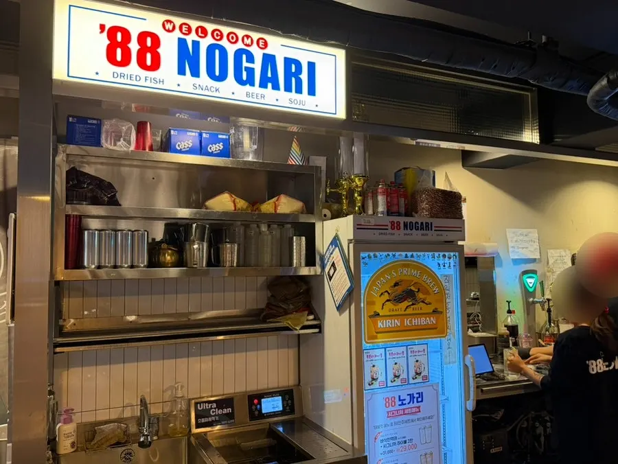Self-serve fridge corner where customers grab their own drinks