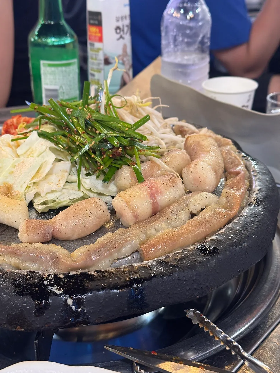 Close-up of staff grilling gopchang on the hot plate