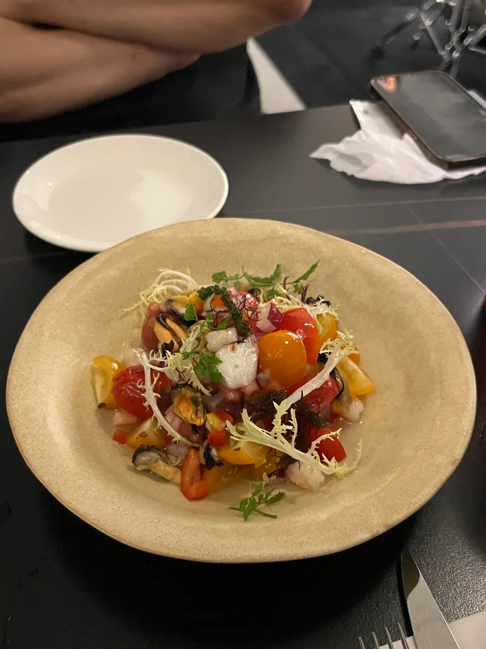 Seafood salad topped with octopus, shrimp, and mussels