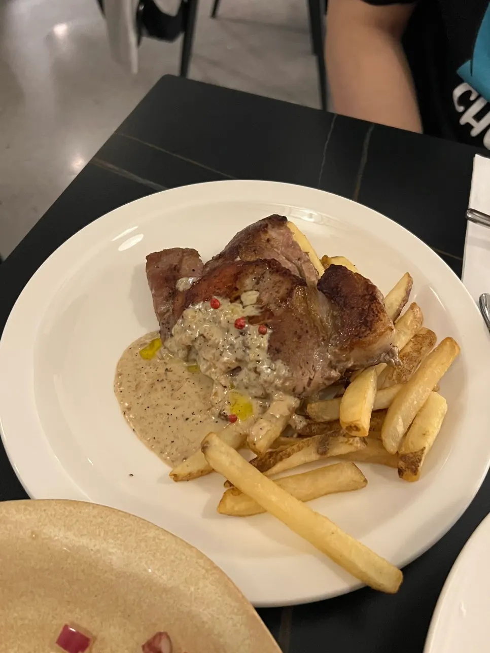 Sous-vide pork shoulder steak served with fries