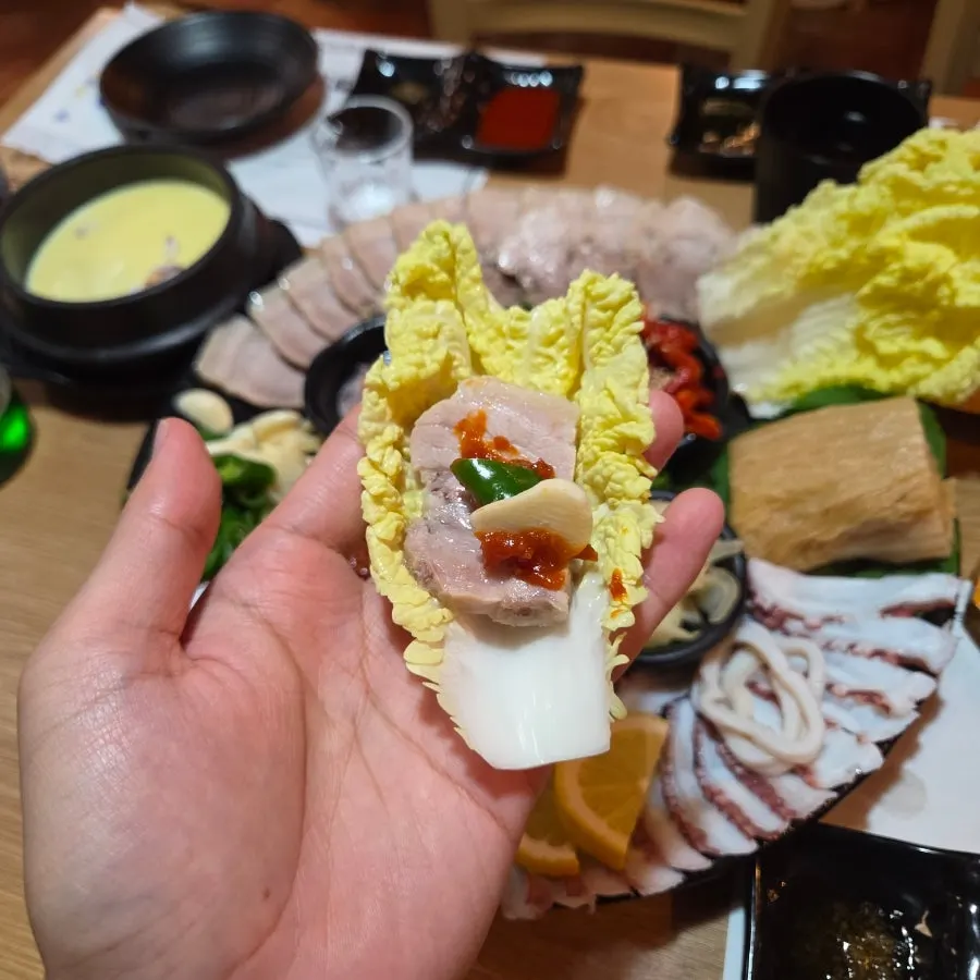 A piece of pork belly dipped in salted shrimp