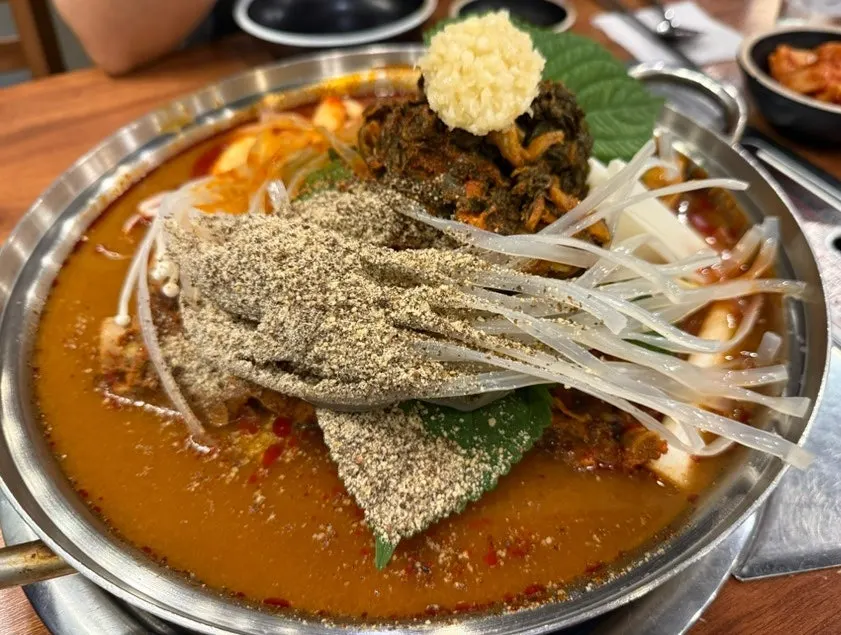 Bone gamjatang boiling with side dishes