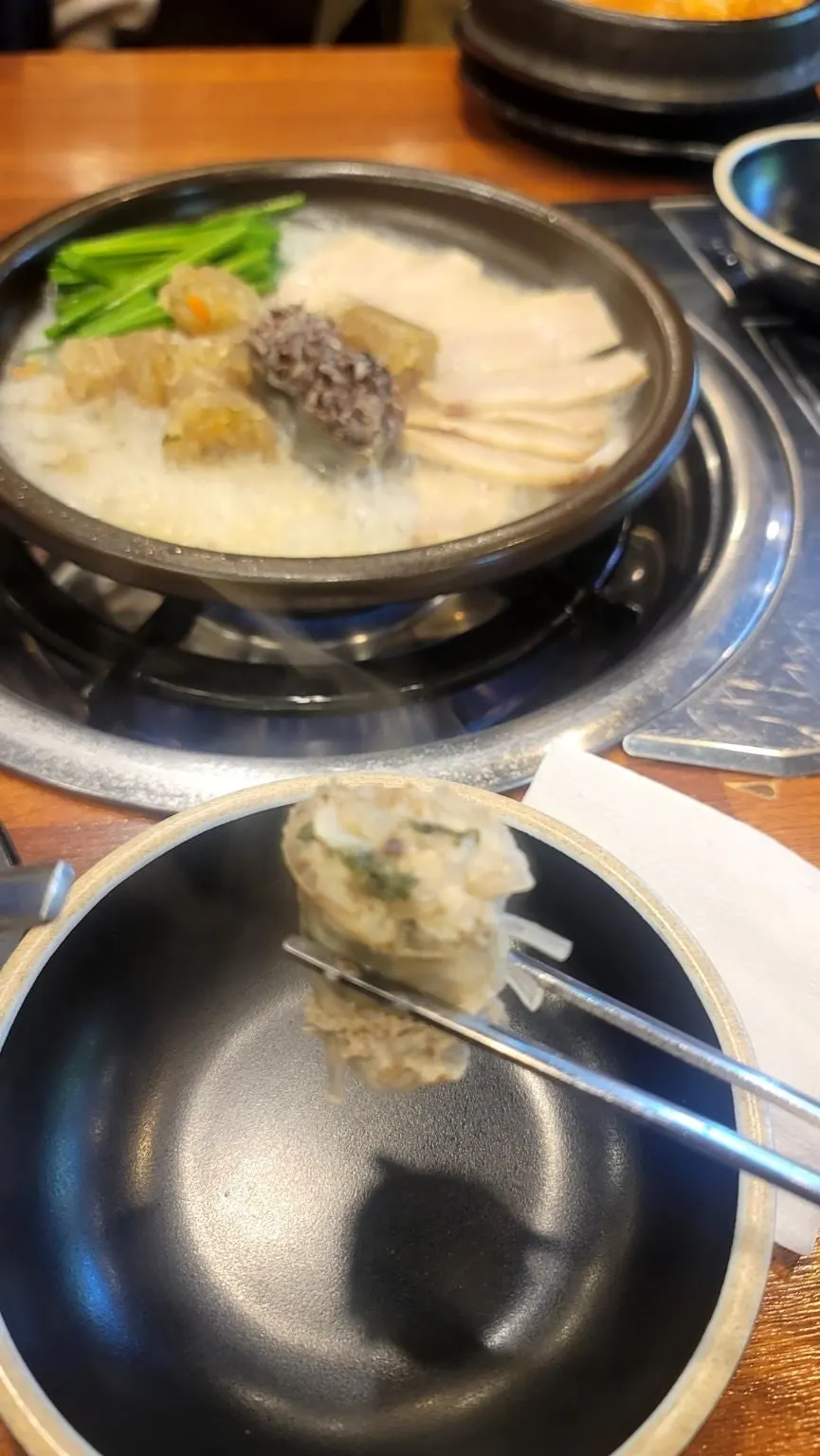 A spoonful heaped with spicy sundaeguk ingredients