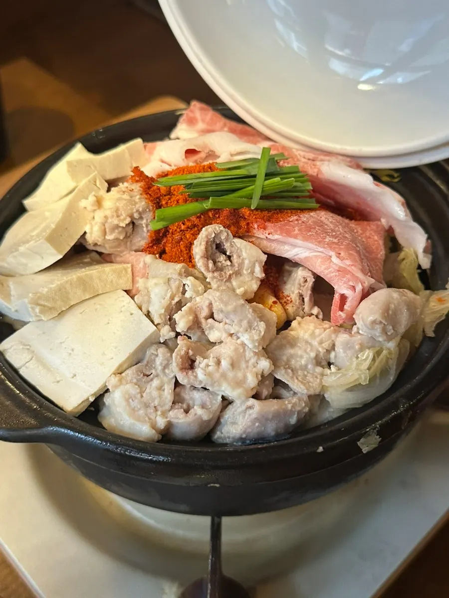 Table spread of gopchang hot pot for two at Horanggul Bangi Branch