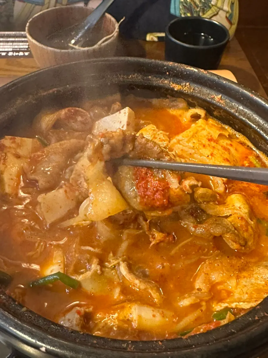 A bite of gopchang hot pot eaten with the broth