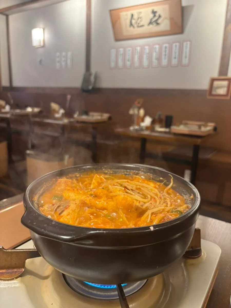 Gopchang jeongol being cooked with mixed seasoning