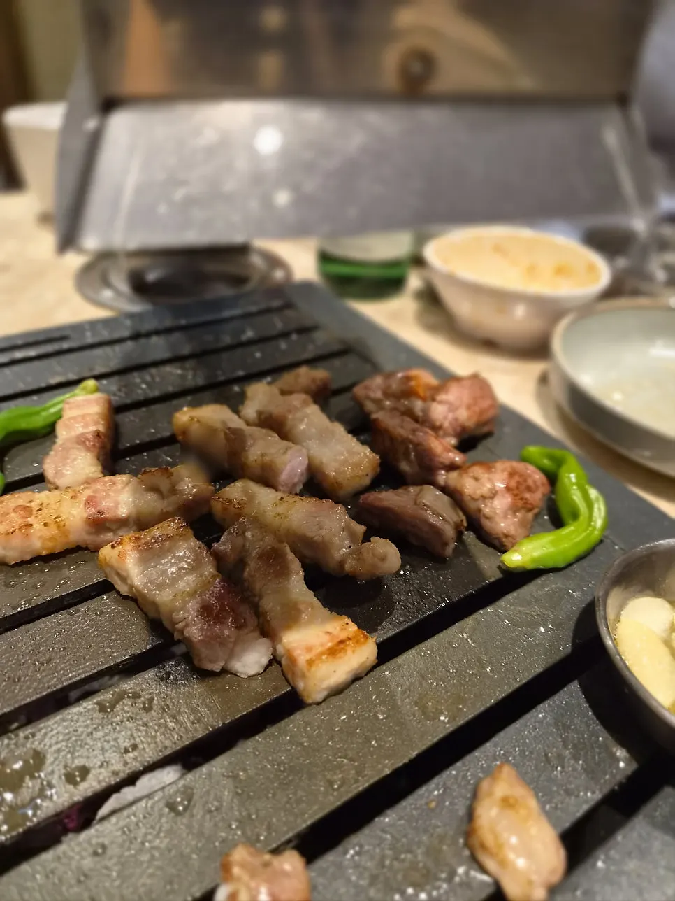 Grill plate with staff grilling the Korean pork sampler