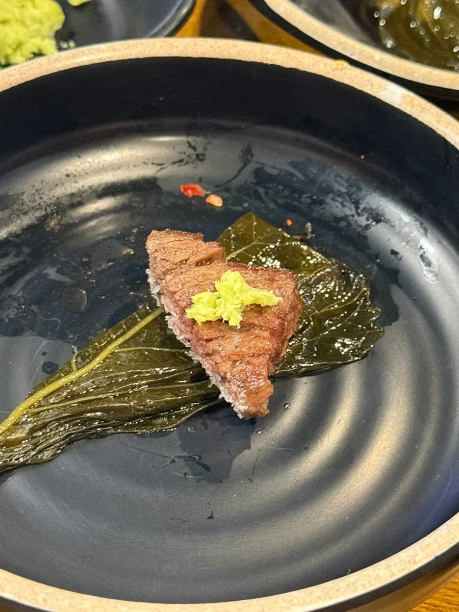 A piece of snowflake galbi topped with wasabi