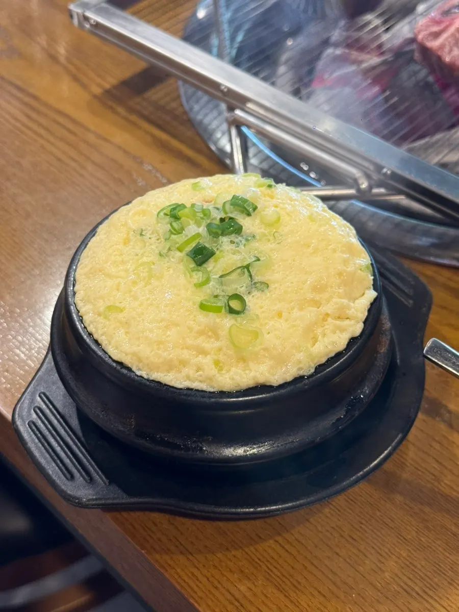 Steamed egg puffed up to the brim of the stone pot