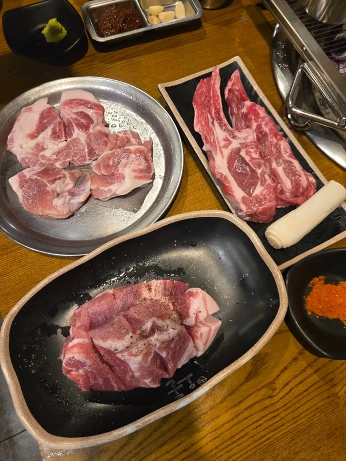 Table spread with lamb ribs, silk mango pork neck, and other ordered meats