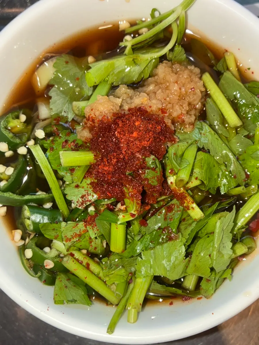 House-made scallion kimchi served as a complimentary side
