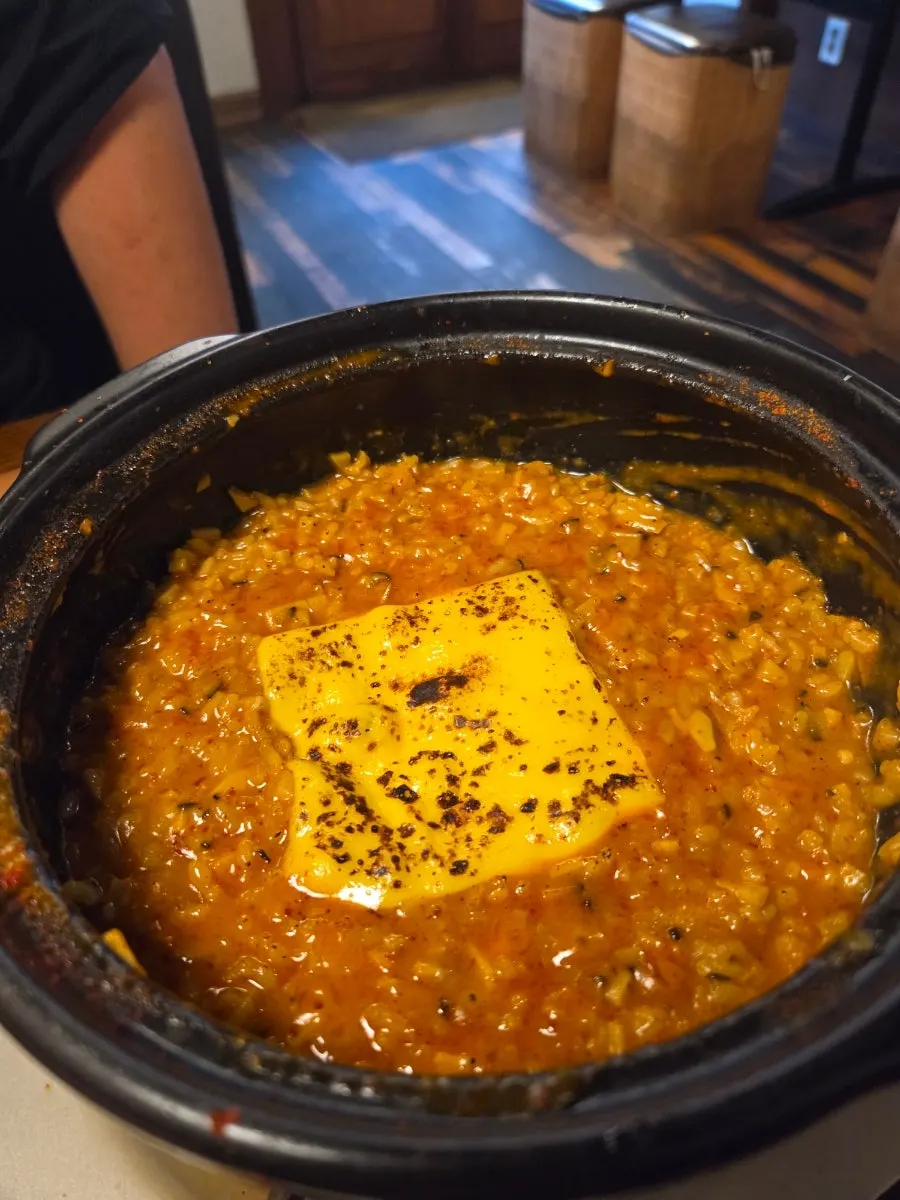 Fried rice topped with mushrooms and cheese