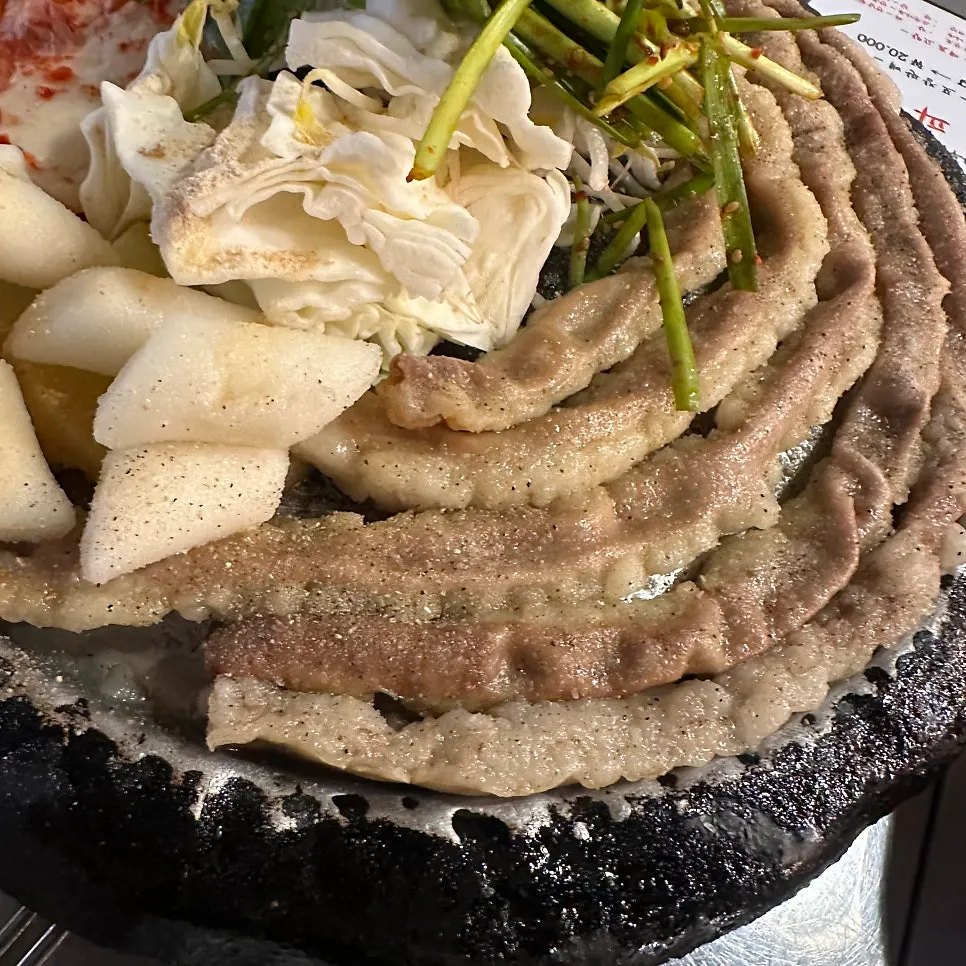 Potatoes, rice cakes, and bean sprouts served with gopchang