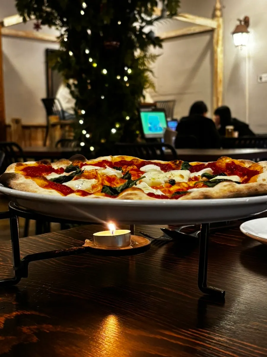 Wood-fired pizza served warm