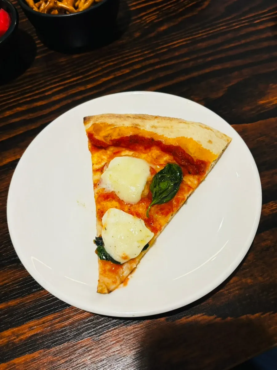 Pizza topped with mozzarella cheese