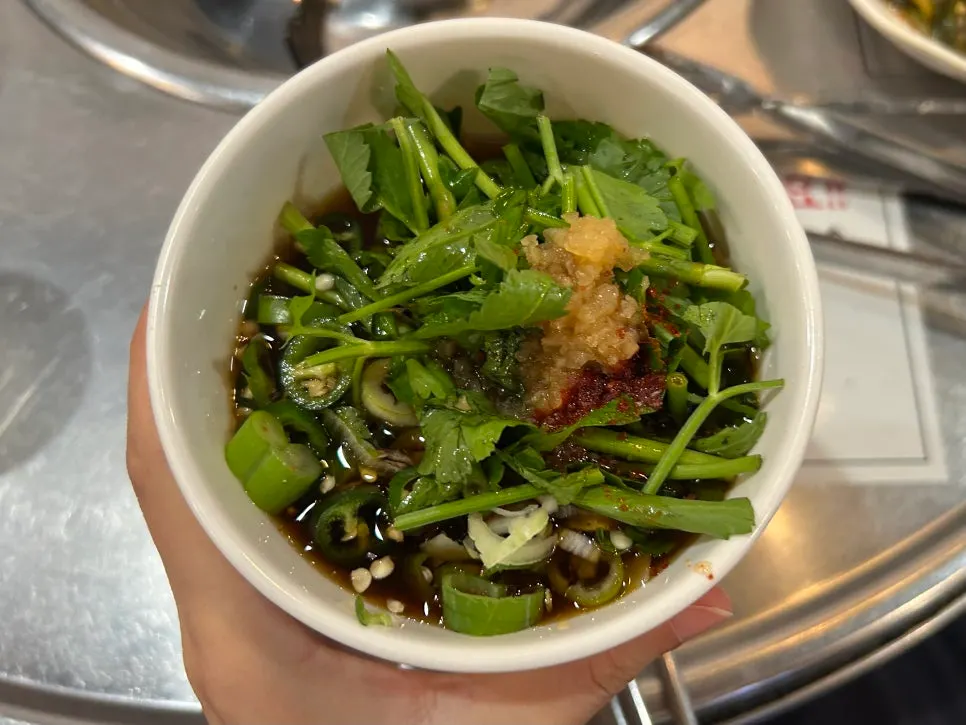 A bowl of pickled minari garlic sauce