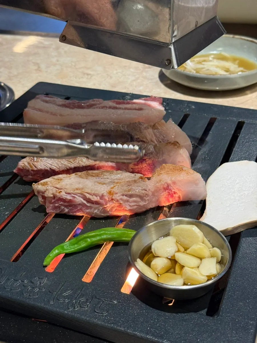 Juicy Korean pork neck grilled by staff