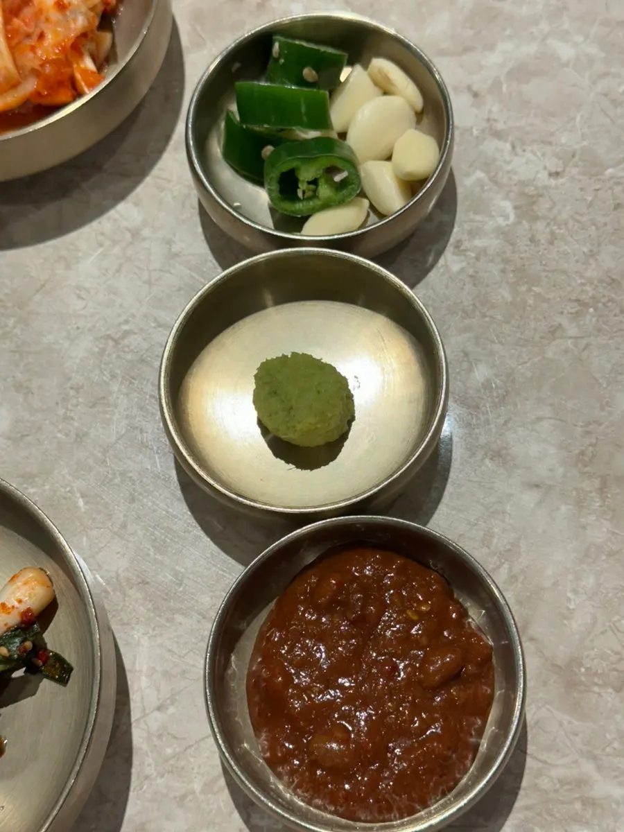 Brassware set holding meat and side dishes