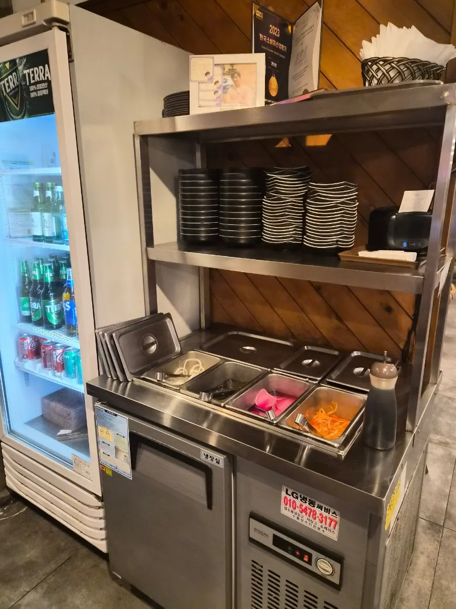 Self-service refill station for complimentary side dishes at Dangsan Odol