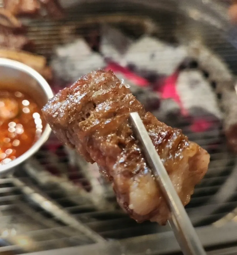 Snowflake ribs grilling over charcoal