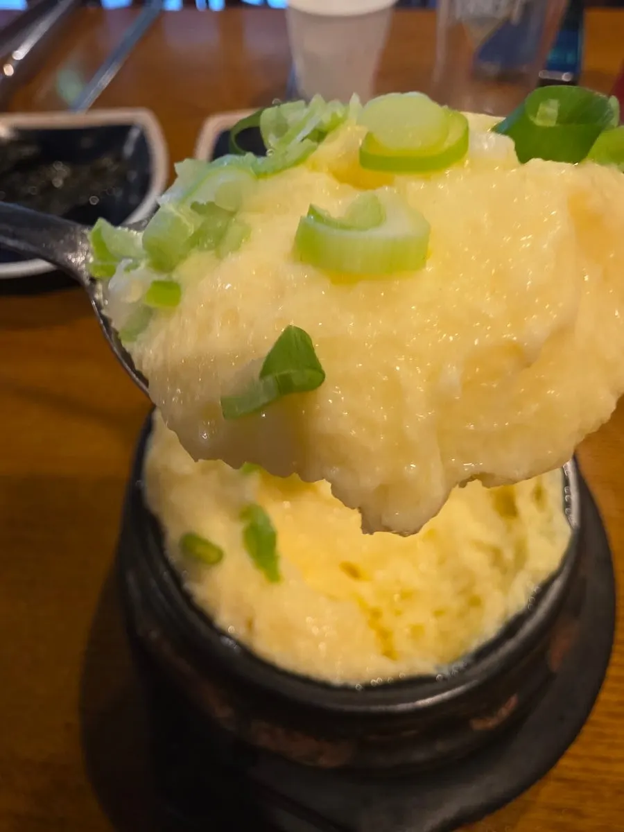 Fluffy steamed egg in an earthenware pot