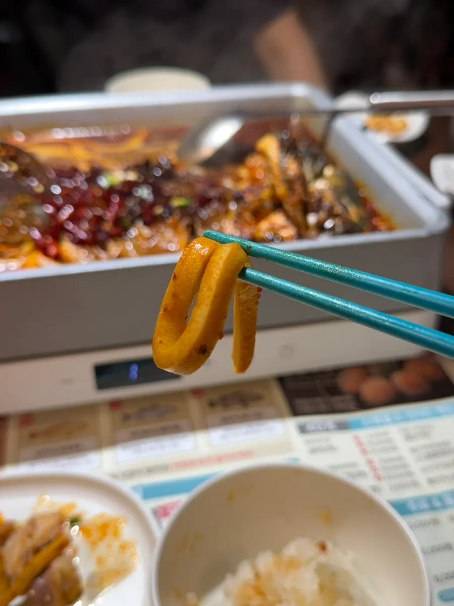 Scooping up noodle-like egg tofu