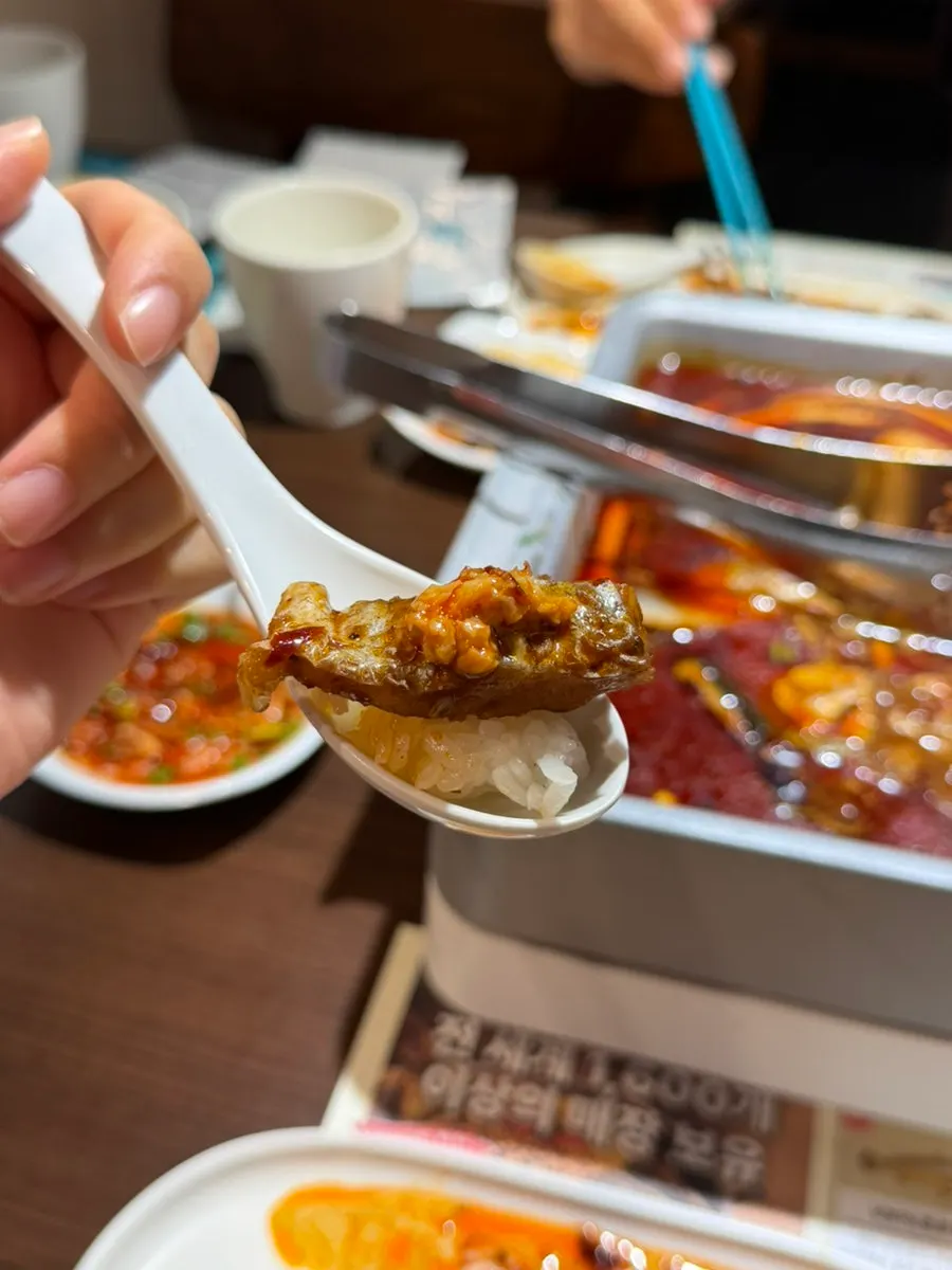 A bite of fish meat topped with peanut sauce