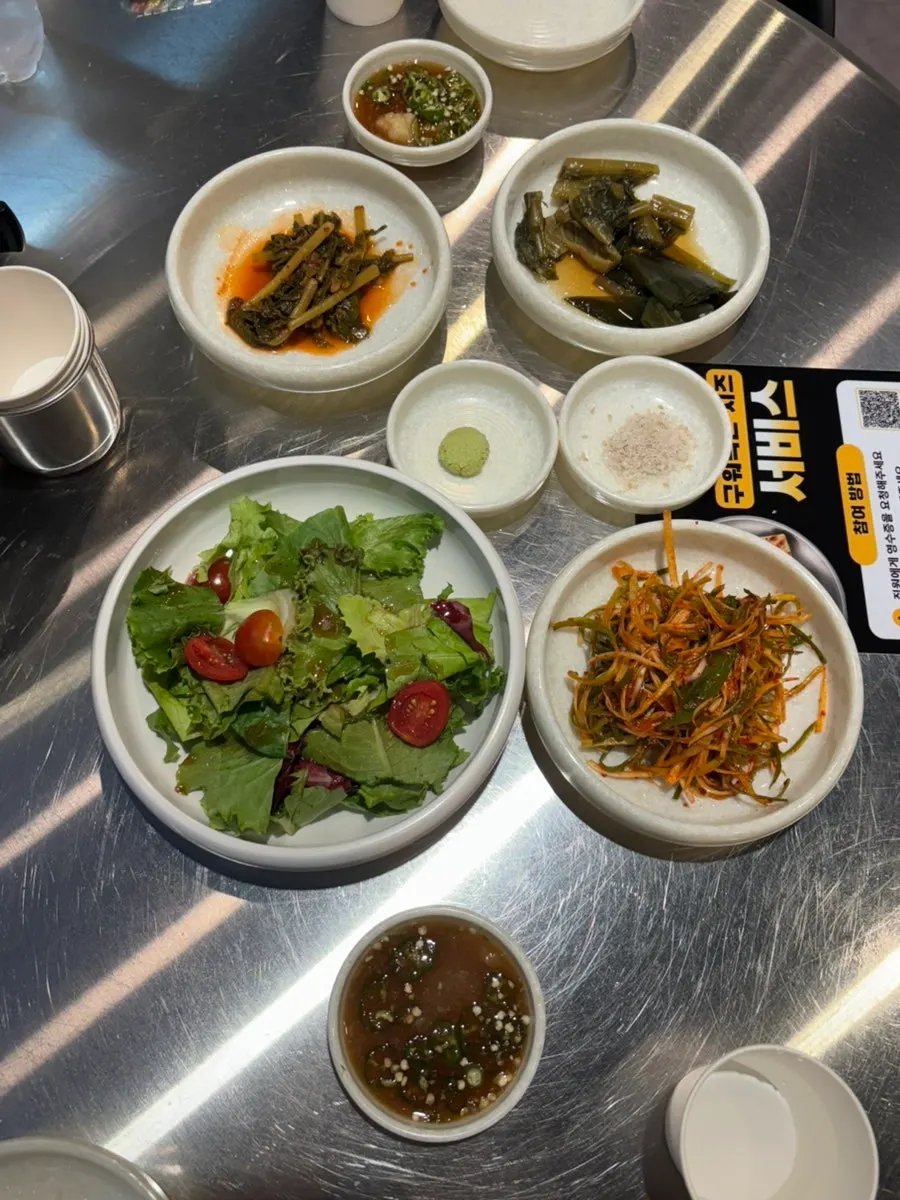 A spread of Ugojip's basic banchan including scallion salad and myeongi-namul