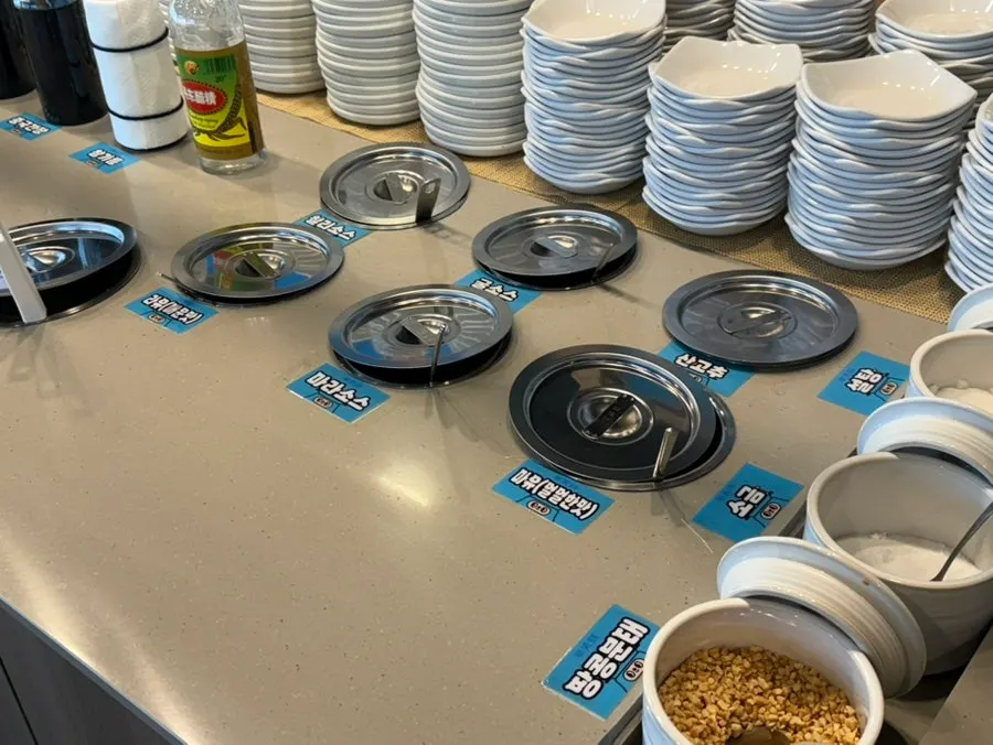 Self-bar sauce station with mala, chili, peanut, and garlic sauces