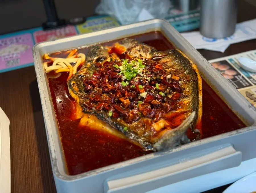 A pan of mala kaoyu piled high with chili peppers