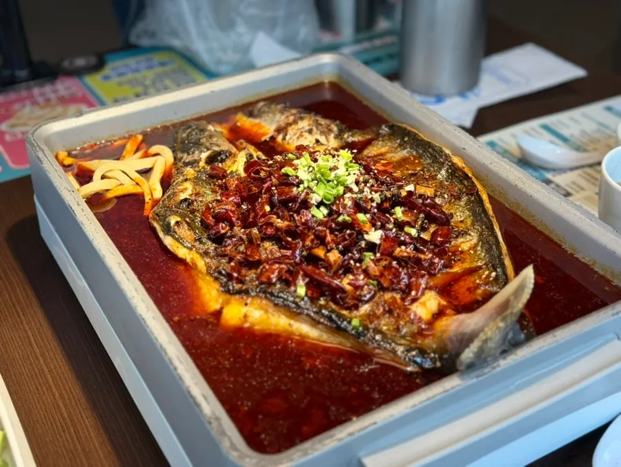 Whole sea bass mala kaoyu in the pan