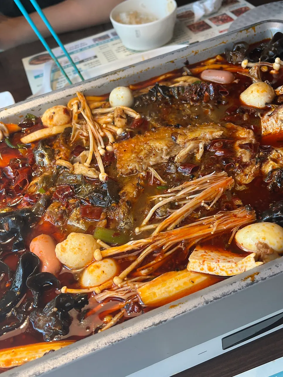 The kaoyu pot simmering with lots of added toppings